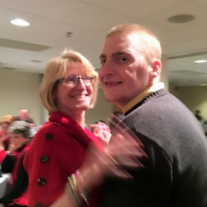 Adult resident dances with his mother at event